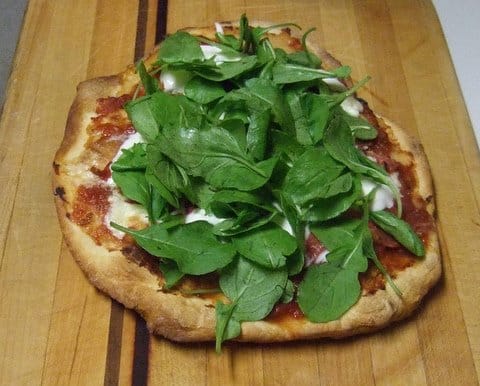 Stracciatella and Prosciutto Pizza with Arugula and Tomato Sauce