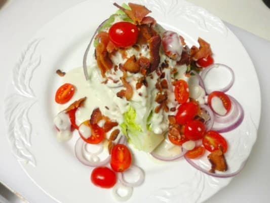 Bay Burger’s Wedge Salad with Blue Cheese Dressing, Tomatoes And Red Onion.