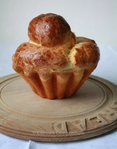 A Bun with a substantial piece of pastry on top