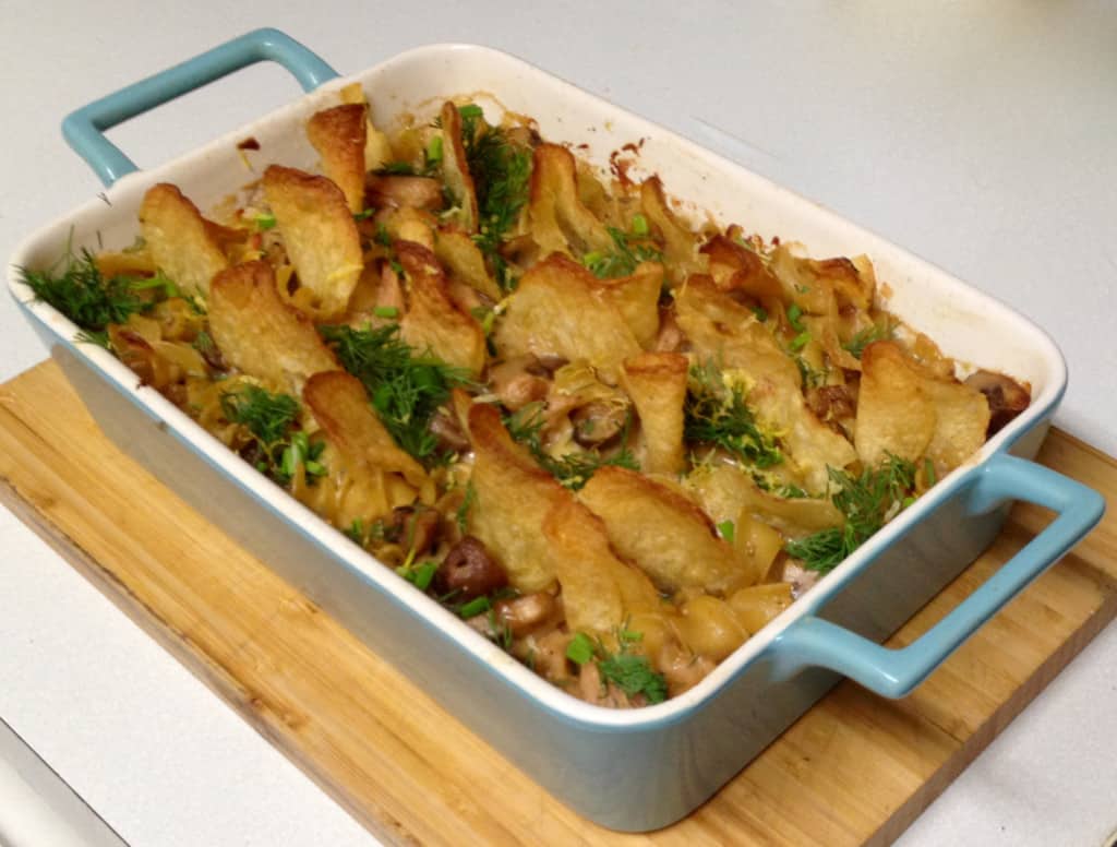 A Tuna Casserole with Dill and Potato Chips is shown in a blue cast iron baking dish