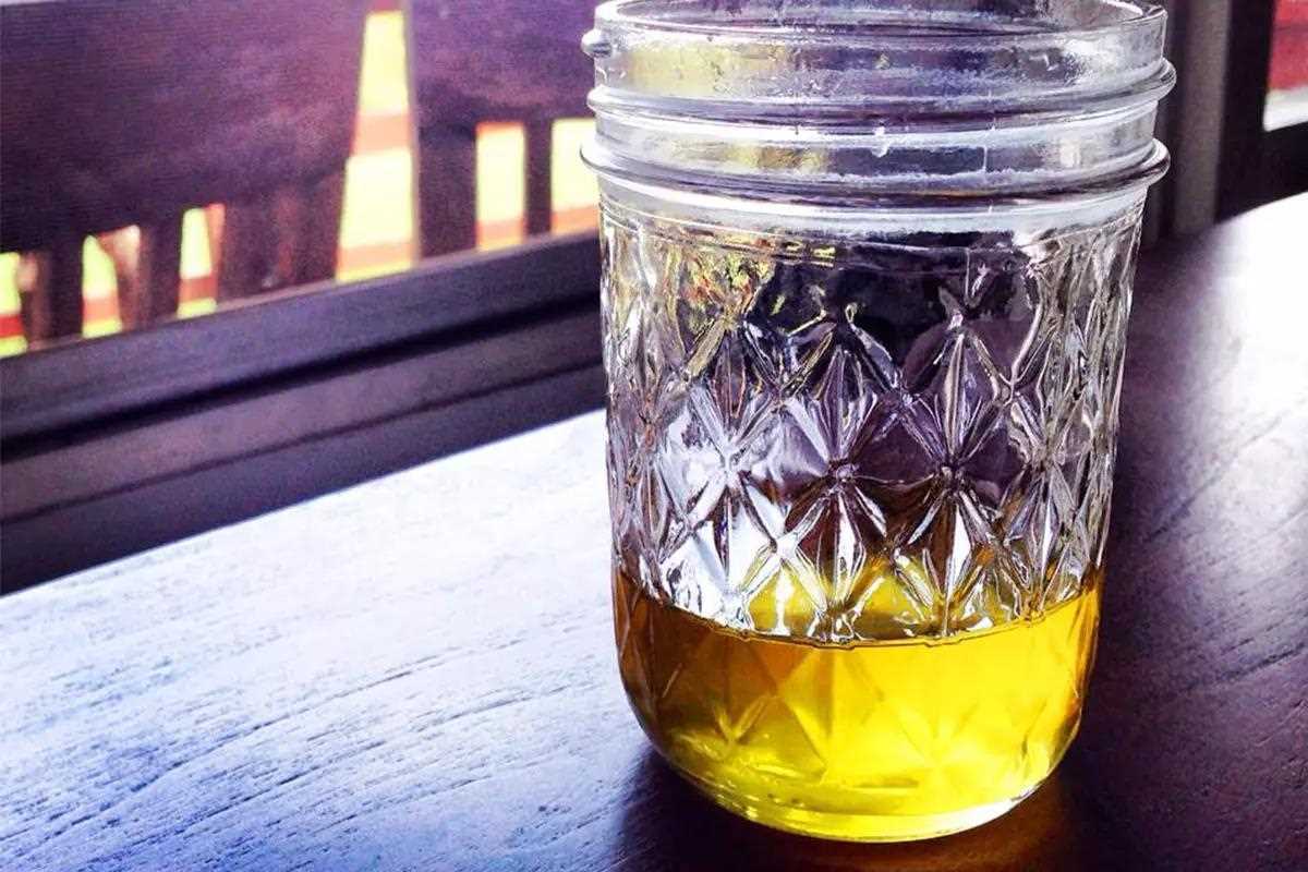 rendered duck fat in glass jar for duck confit cooking