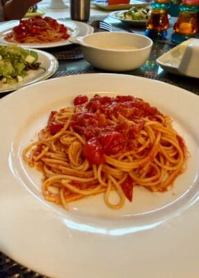 A BIG BOWL OF GRAPE TOMATOES, A POUND OF SPAGHETTI AND DINNER IS SERVED.