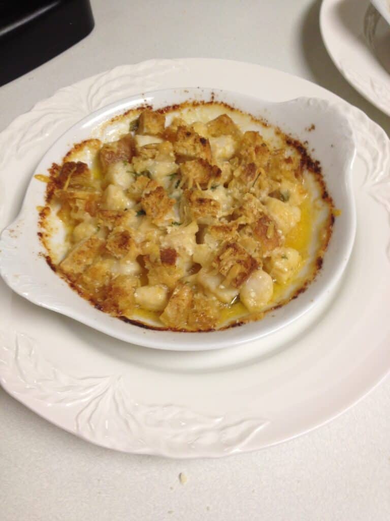 Scallops in a ramekin with a crusty bread topping