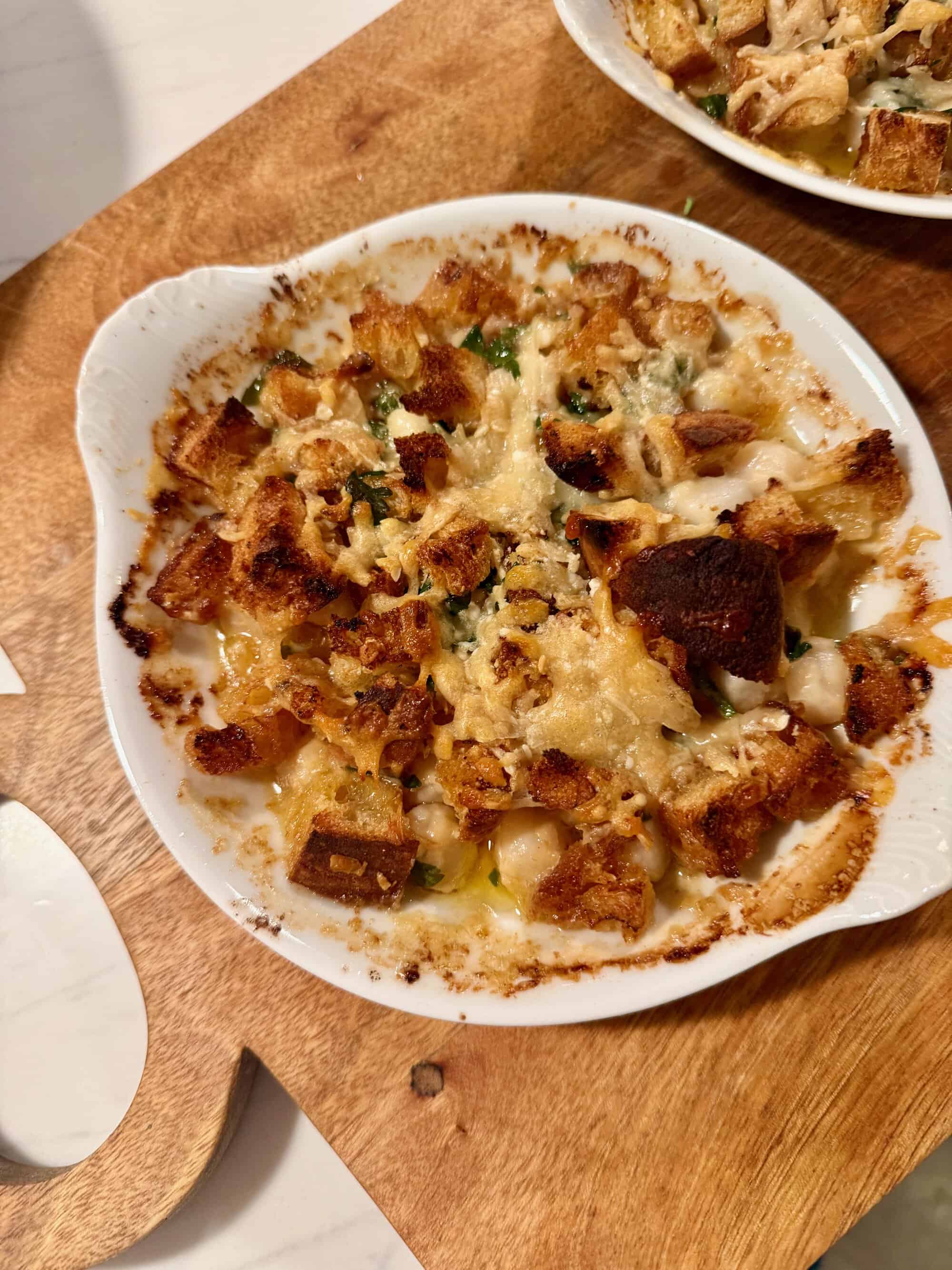 BAKED BAY SCALLOPS WITH HOT-SAUCE BUTTER, PARMESAN AND CROUTONS.